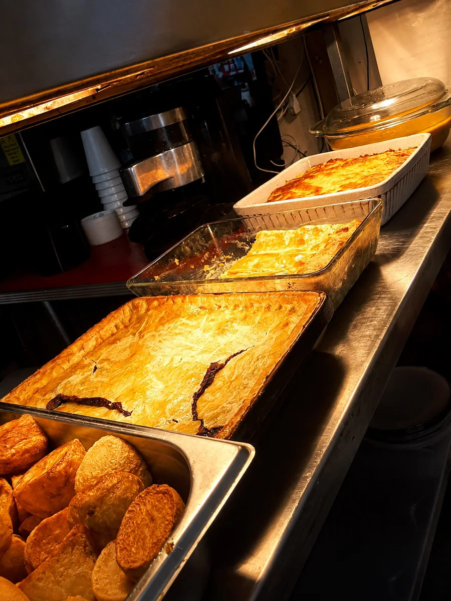 Hot savoury dishes ready on the cafe counter